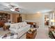 Inviting living room with ceiling fan, neutral walls, and access to bedroom hallway at 14195 Holly Berry Cir, Fishers, IN 46038