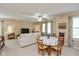 Comfortable living room features a dining area, neutral tones and a ceiling fan at 14195 Holly Berry Cir, Fishers, IN 46038