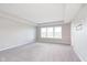 Spacious bedroom featuring tray ceilings, carpet flooring, and large windows at 14878 Horse Branch Way, Fishers, IN 46040
