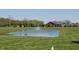 Pond with fountain in a community with manicured lawn and surrounding homes at 14878 Horse Branch Way, Fishers, IN 46040