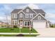 Charming two-story home featuring a manicured lawn and a classic gray and white exterior at 14878 Horse Branch Way, Fishers, IN 46040