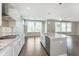 Open kitchen with granite island, stainless appliances, and hardwood floors perfect for entertaining at 14878 Horse Branch Way, Fishers, IN 46040