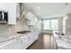 Bright kitchen with stainless steel appliances, granite counters, and a view of the backyard at 14878 Horse Branch Way, Fishers, IN 46040