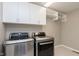 Well-organized laundry room featuring modern washer and dryer, ample storage cabinets, and bright lighting at 14878 Horse Branch Way, Fishers, IN 46040