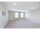Spacious, light-filled living room with neutral carpet, recessed lighting, and large windows for ample natural light at 14878 Horse Branch Way, Fishers, IN 46040