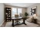Well-lit home office with large desk, built-in shelves, and comfortable seating at 14878 Horse Branch Way, Fishers, IN 46040