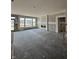Unfinished living room featuring large windows and a fireplace, perfect for creating a cozy space at 14910 Garden Mist Pl, Fishers, IN 46037