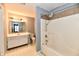 Bathroom with shower and tub combo, white vanity, and neutral walls at 1632 Blankenship Dr, Indianapolis, IN 46217
