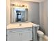 Bathroom with white vanity, mirror, and tile flooring at 1632 Blankenship Dr, Indianapolis, IN 46217