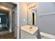 Neutral bathroom includes a single sink vanity and modern lighting at 1632 Blankenship Dr, Indianapolis, IN 46217