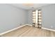 Cozy bedroom with gray walls, wood floors, and plenty of natural light at 1632 Blankenship Dr, Indianapolis, IN 46217