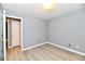 Cozy bedroom featuring wood-look floors, neutral walls, and ample natural light with a double door closet at 1632 Blankenship Dr, Indianapolis, IN 46217