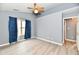 Bedroom with a ceiling fan, window, and wood-look flooring at 1632 Blankenship Dr, Indianapolis, IN 46217