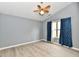 Bedroom featuring wood-look floors, ceiling fan, and window with curtains at 1632 Blankenship Dr, Indianapolis, IN 46217