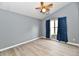 Bedroom with wood-look flooring, neutral paint, and blue drapes at 1632 Blankenship Dr, Indianapolis, IN 46217