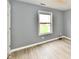 Bedroom with wood-look floors, window with shades, and neutral walls at 1632 Blankenship Dr, Indianapolis, IN 46217