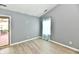Bedroom featuring wood-look floors, a window, and a sliding door to a deck at 1632 Blankenship Dr, Indianapolis, IN 46217