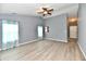 Spacious living room with ceiling fan and wood-look flooring at 1632 Blankenship Dr, Indianapolis, IN 46217
