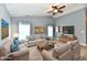 Bright living room with neutral tones, a ceiling fan, and ample seating space for relaxation at 1632 Blankenship Dr, Indianapolis, IN 46217