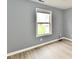 Bright room featuring modern vinyl floors, neutral walls, and a view from the living room to the kitchen at 1632 Blankenship Dr, Indianapolis, IN 46217