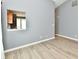 Open living room with an opening into the kitchen and durable, wood-look flooring at 1632 Blankenship Dr, Indianapolis, IN 46217