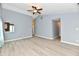 Inviting living room with wood-look floors, neutral walls, a ceiling fan, and an open layout to the kitchen at 1632 Blankenship Dr, Indianapolis, IN 46217