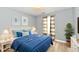 Relaxing blue bedroom with bright lighting, soft accents, and stylish modern decor at 1632 Blankenship Dr, Indianapolis, IN 46217