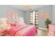 Bright pink bedroom with soft lighting, cheerful decor, and a cozy atmosphere at 1632 Blankenship Dr, Indianapolis, IN 46217