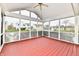 Spacious screened porch with red floors provides an outdoor living space at 1632 Blankenship Dr, Indianapolis, IN 46217