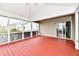 Large screened-in porch with red flooring, perfect for relaxing or entertaining at 1632 Blankenship Dr, Indianapolis, IN 46217