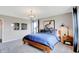 Well-lit bedroom with a warm wooden bed frame, stylish artwork, and plenty of natural light at 16930 Sandhurst Pl, Westfield, IN 46074
