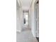 Well-lit hallway with carpeted floors and access to several rooms, offering a sense of spaciousness at 16930 Sandhurst Pl, Westfield, IN 46074