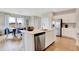 Bright, open kitchen featuring white cabinets, a center island, stainless steel appliances, and adjacent dining area at 16930 Sandhurst Pl, Westfield, IN 46074