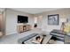 Open living area featuring modern decor, a large TV, and view into another room at 16930 Sandhurst Pl, Westfield, IN 46074