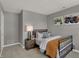 Inviting bedroom featuring neutral tones, tractor-themed artwork, and soft carpet at 17001 Fulsam St, Westfield, IN 46074