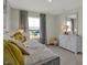 Inviting bedroom with a large window, stylish decor, and a white dresser with mirror at 17001 Fulsam St, Westfield, IN 46074
