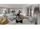Inviting living room showcasing hardwood floors, comfortable seating, and seamlessly connecting to the kitchen at 17001 Fulsam St, Westfield, IN 46074