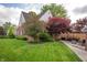 Large backyard with mature trees, a well-manicured lawn, and patio area at 171 W 44Th St, Indianapolis, IN 46208