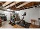 Unfinished basement with exposed ceiling, workout bike, storage shelving, and potential for customization at 171 W 44Th St, Indianapolis, IN 46208
