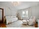 Cozy bedroom with a daybed, armchair, and light hardwood floors for relaxing and unwinding at 171 W 44Th St, Indianapolis, IN 46208
