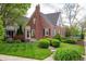Charming brick home with manicured lawn and lush landscaping offers timeless curb appeal at 171 W 44Th St, Indianapolis, IN 46208