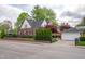 Charming brick home with a well-manicured lawn, fenced yard, and detached garage and driveway at 171 W 44Th St, Indianapolis, IN 46208