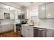 Well-lit kitchen featuring white cabinets, stainless steel appliances, and hardwood floors at 171 W 44Th St, Indianapolis, IN 46208