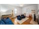 Bright playroom with hardwood floors, blue sofa, two chairs, storage shelves, and a playful giraffe toy at 171 W 44Th St, Indianapolis, IN 46208