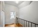 Bright stairwell with light colored walls and wood flooring; natural light shines through a window at 171 W 44Th St, Indianapolis, IN 46208