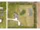 An aerial view of the home showcases a well kept yard, a small pond, and a detached garage at 180 S 400 W, Lebanon, IN 46052