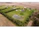 Aerial view of a home on a large parcel, features a pond and several outbuildings at 180 S 400 W, Lebanon, IN 46052