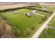 Aerial view of property showcasing the home, pond, expansive yard, and surrounding greenery at 180 S 400 W, Lebanon, IN 46052