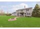 Beautiful backyard with a fire pit and expansive lawn, with a view of the home at 180 S 400 W, Lebanon, IN 46052