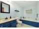 Charming bathroom with a blue vanity, tub, and light fixtures at 180 S 400 W, Lebanon, IN 46052